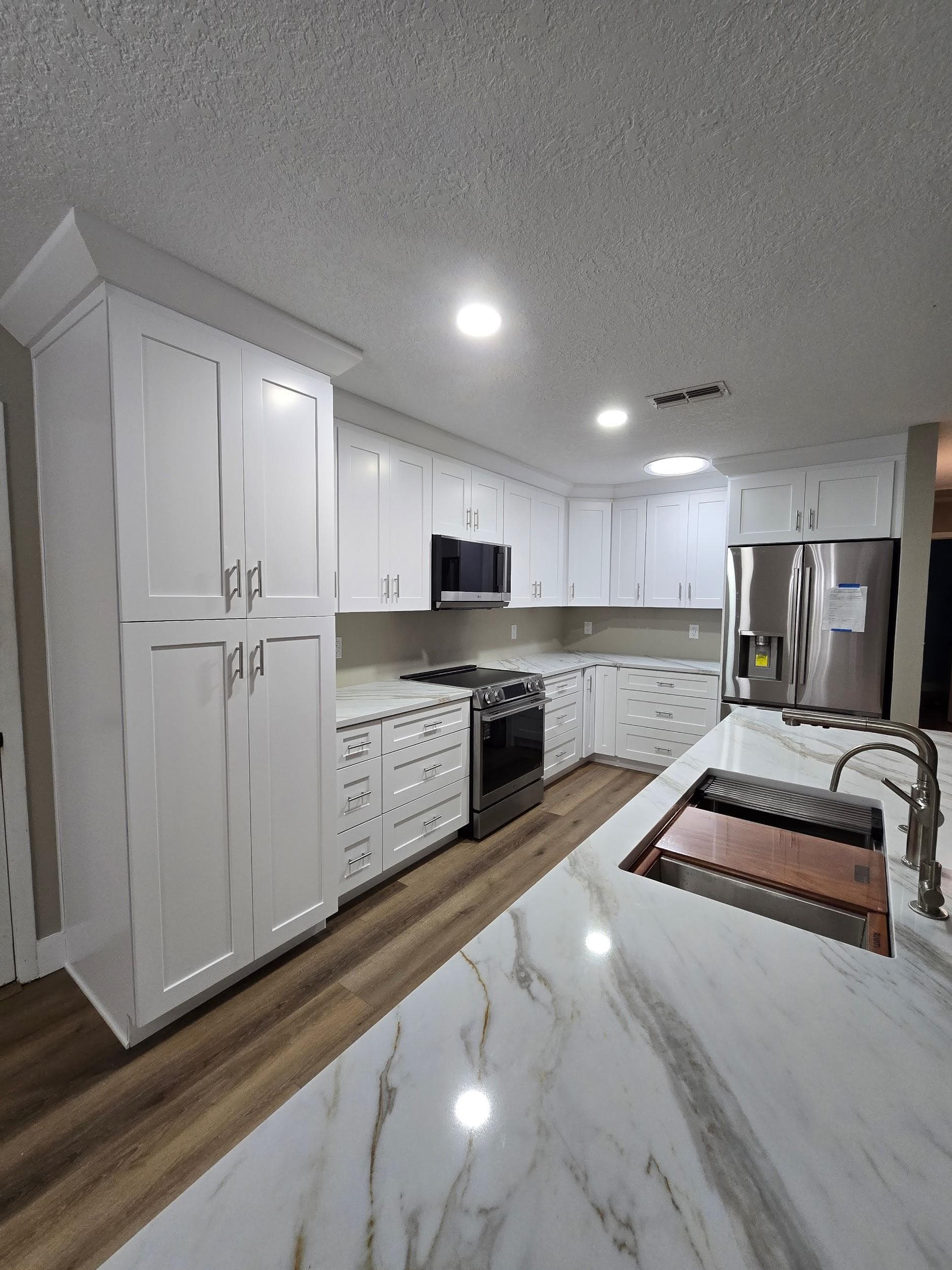 Kitchen remodeling in Seffner FL with custom cabinets, quartz or granite countertops, backsplash, modern lighting, open concept design and new flooring