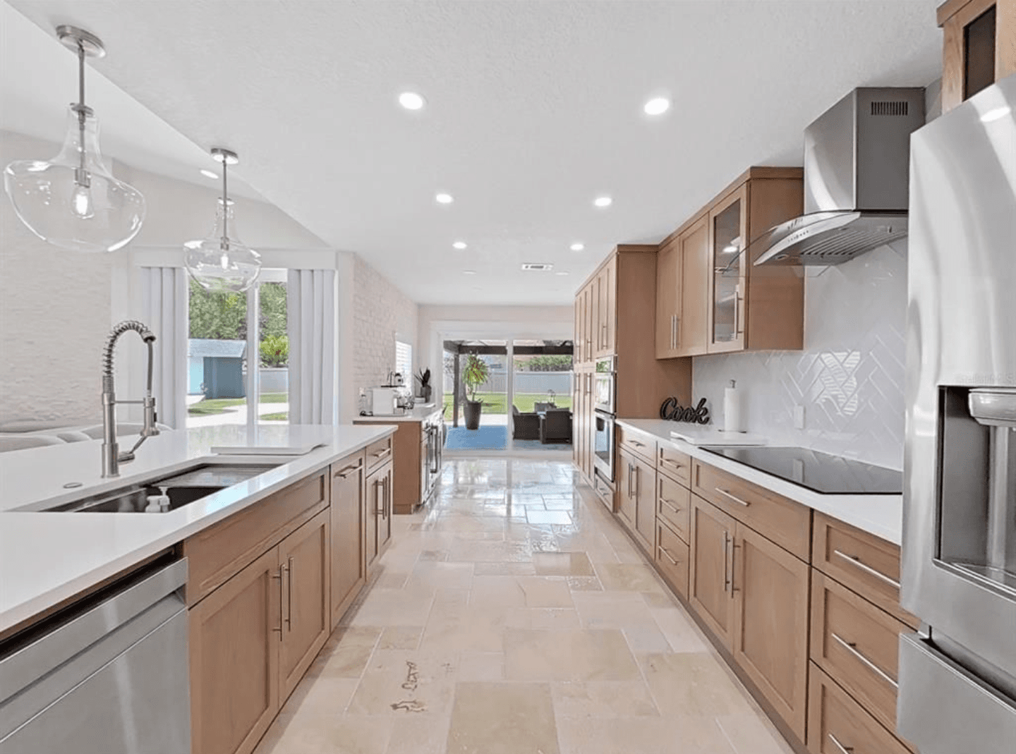 Kitchen remodeling in Pinellas Park FL with custom cabinets, quartz or granite countertops, backsplash, modern lighting, open concept design and new flooring