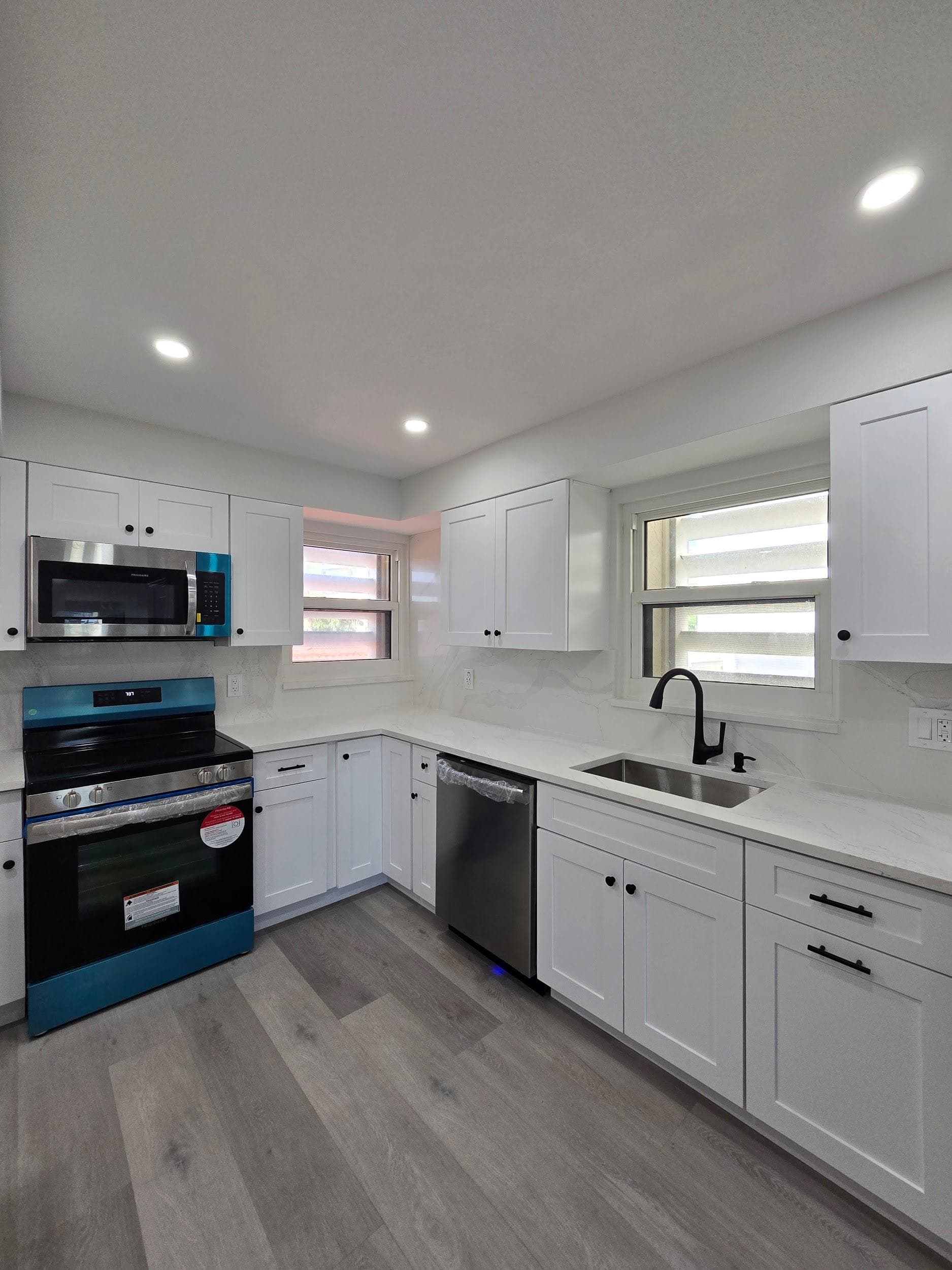 Kitchen remodeling in St. Petersburg FL with custom cabinets, quartz or granite countertops, backsplash, modern lighting, open concept design and new flooring