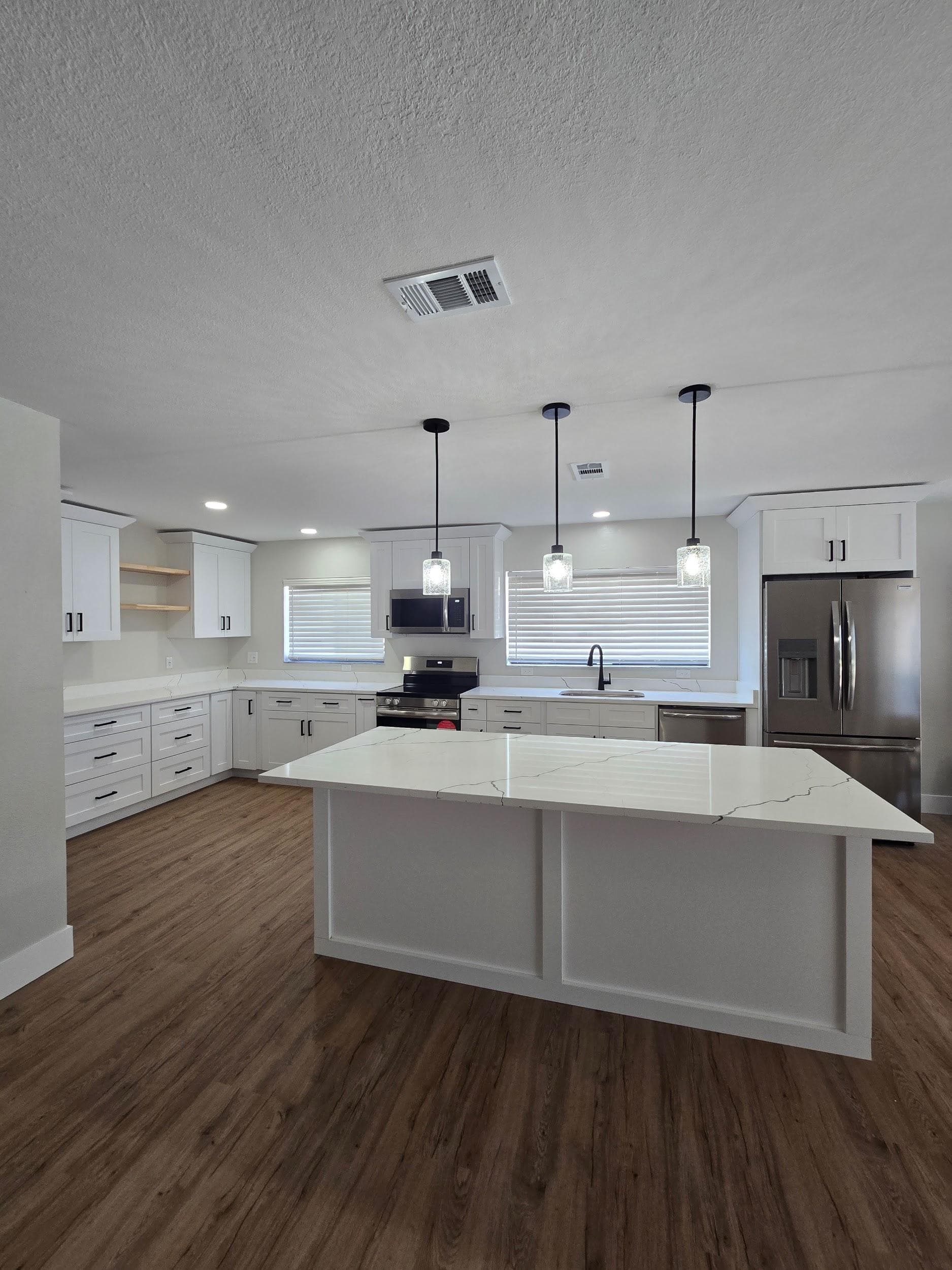 Kitchen remodeling in Seminole FL with custom cabinets, quartz or granite countertops, backsplash, modern lighting, open concept design and new flooring