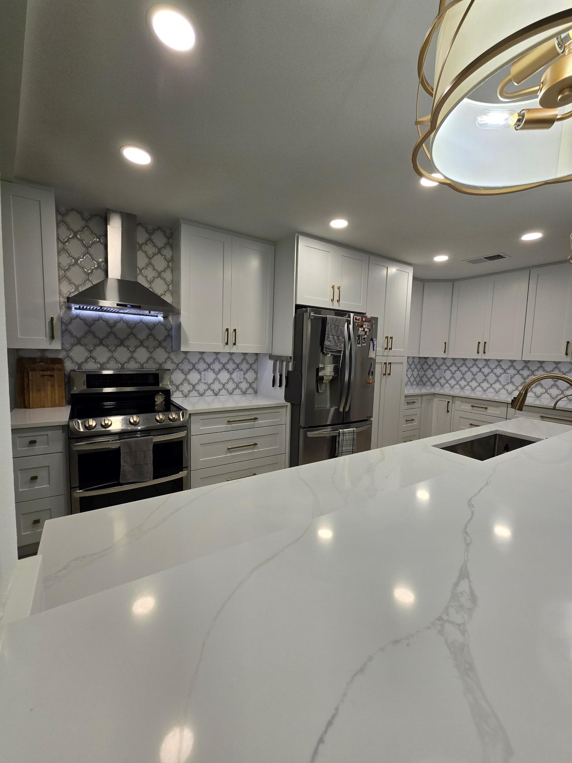 Kitchen remodeling in Town 'n' Country FL with custom cabinets, quartz or granite countertops, backsplash, modern lighting, open concept design and new flooring