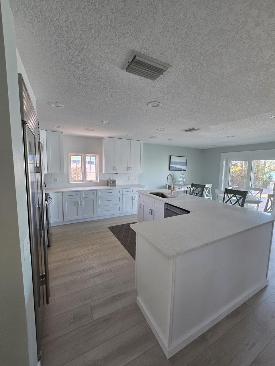 Kitchen remodeling in Keystone FL with custom cabinets, quartz or granite countertops, backsplash, modern lighting, open concept design and new flooring