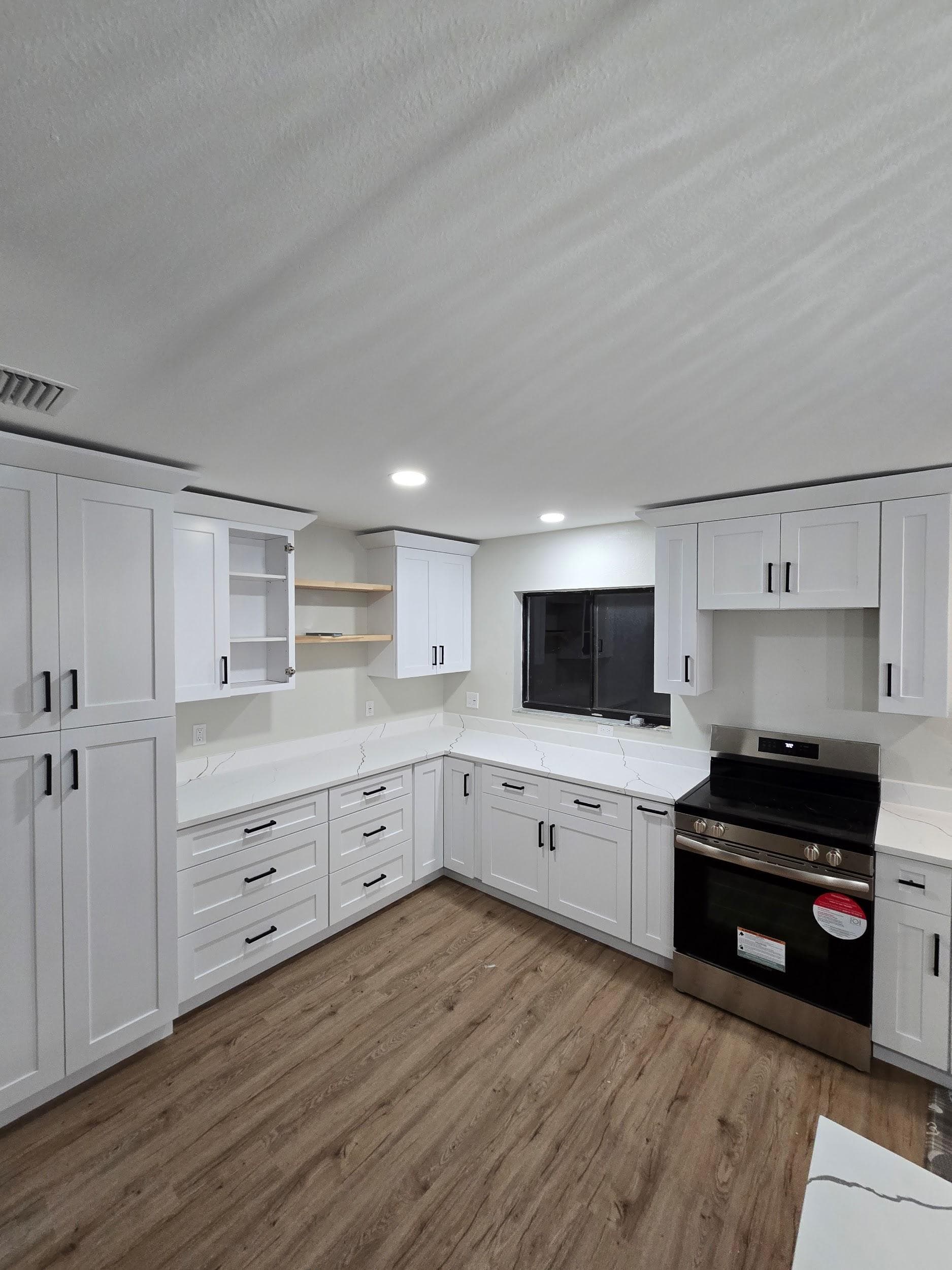 Kitchen remodeling in Ruskin FL with custom cabinets, quartz or granite countertops, backsplash, modern lighting, open concept design and new flooring
