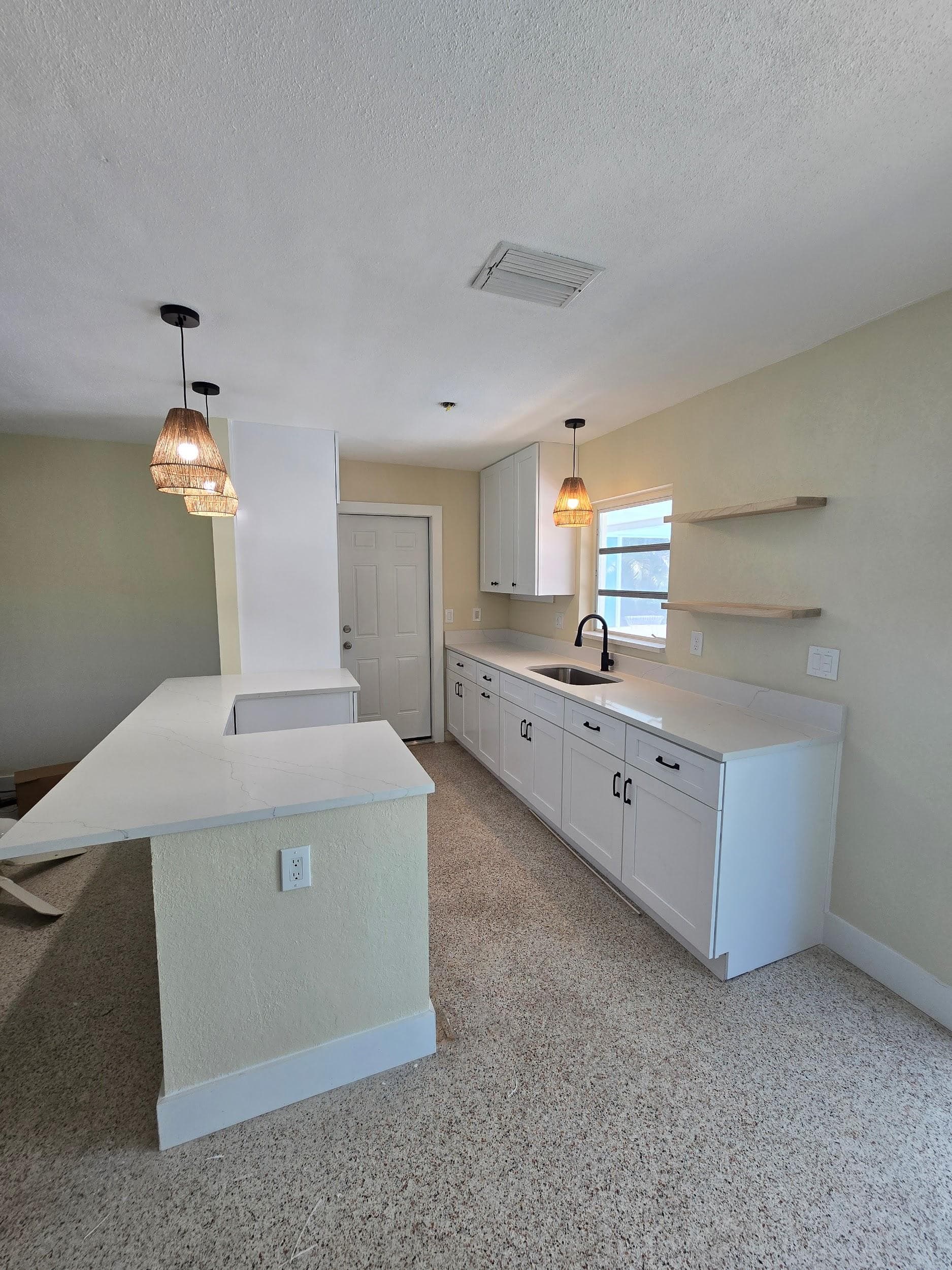 Kitchen remodeling in Sun City Center FL with custom cabinets, quartz or granite countertops, backsplash, modern lighting, open concept design and new flooring