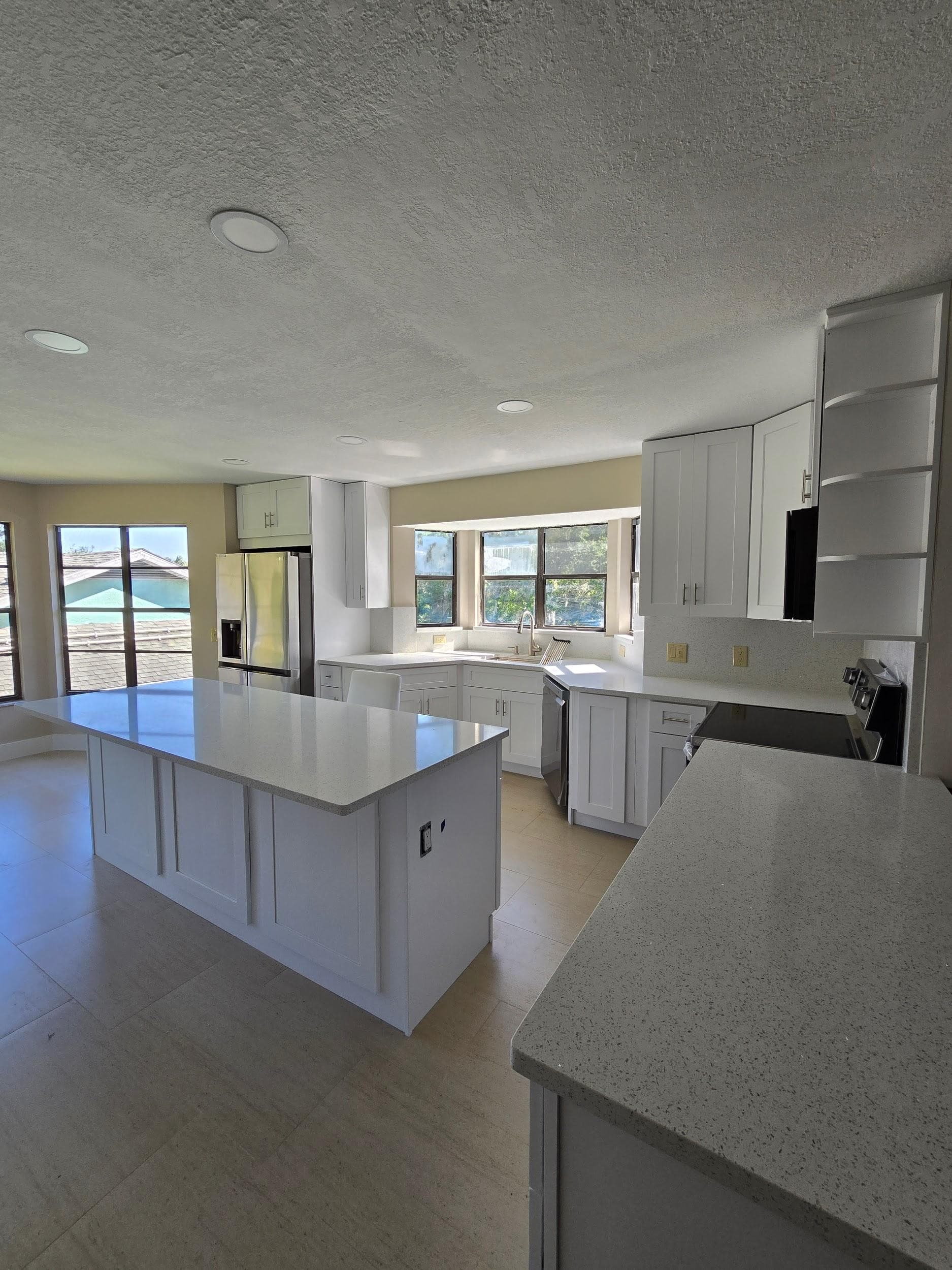 Kitchen remodeling in Cheval FL with custom cabinets, quartz or granite countertops, backsplash, modern lighting, open concept design and new flooring