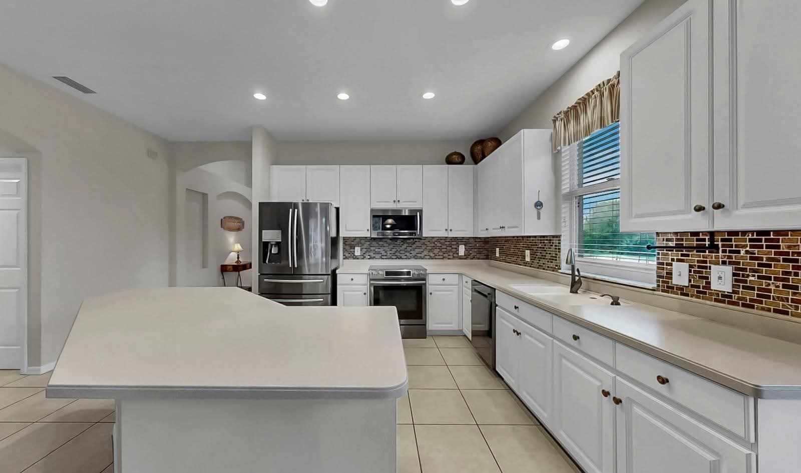 Kitchen remodeling in Mango FL with custom cabinets, quartz or granite countertops, backsplash, modern lighting, open concept design and new flooring