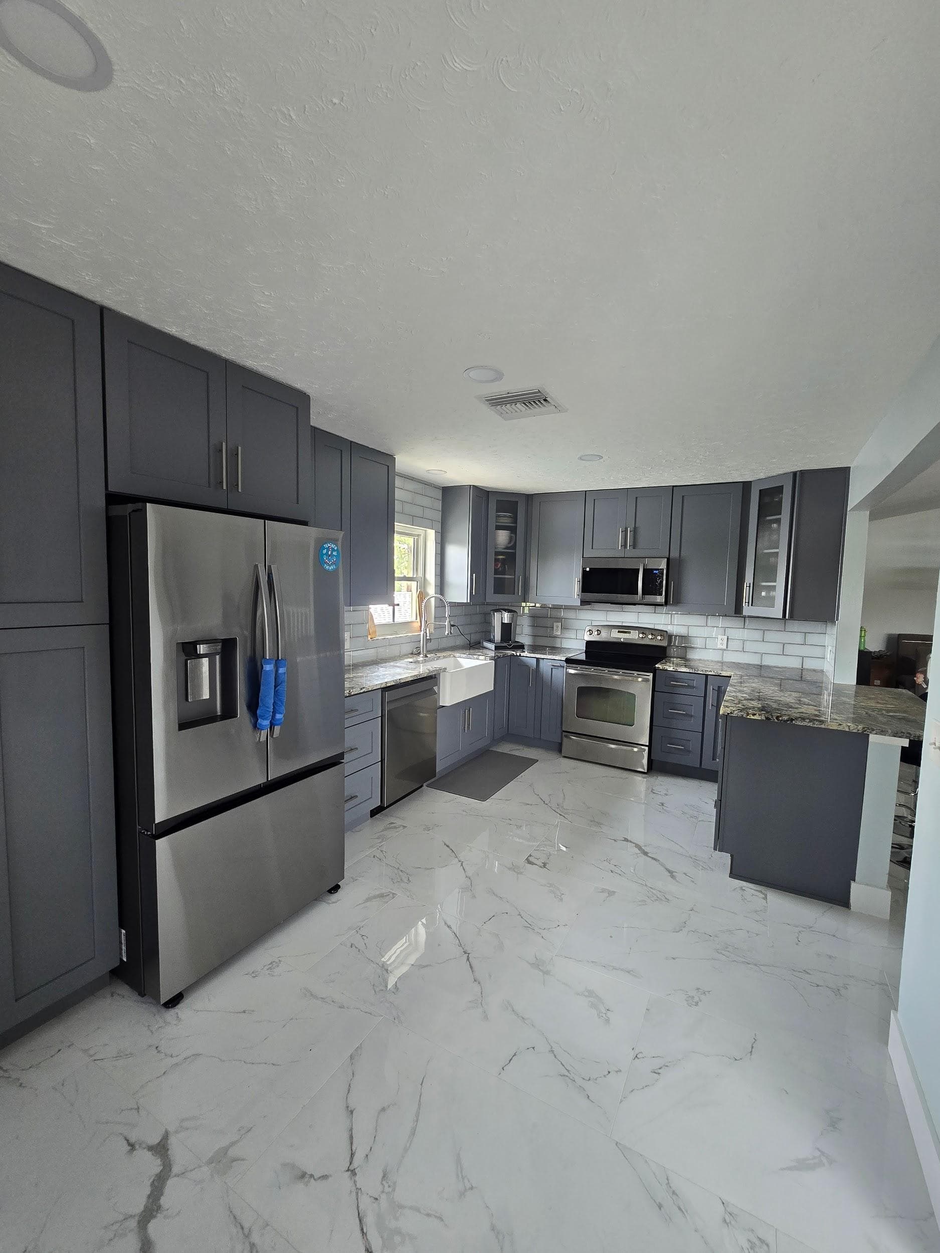 Kitchen remodeling in Carrollwood FL with custom cabinets, quartz or granite countertops, backsplash, modern lighting, open concept design and new flooring