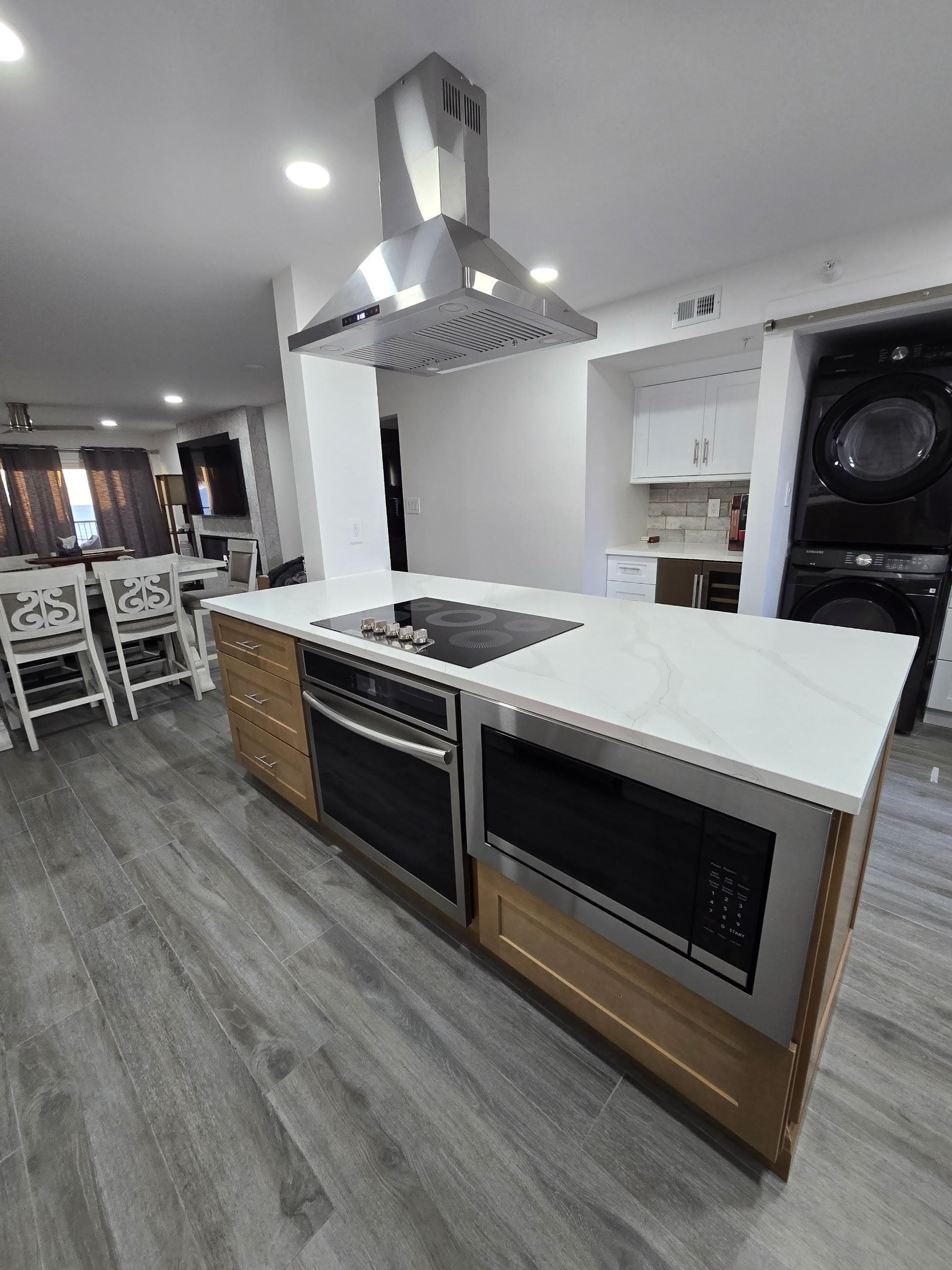Kitchen remodeling in South Tampa FL with custom cabinets, quartz or granite countertops, backsplash, modern lighting, open concept design and new flooring