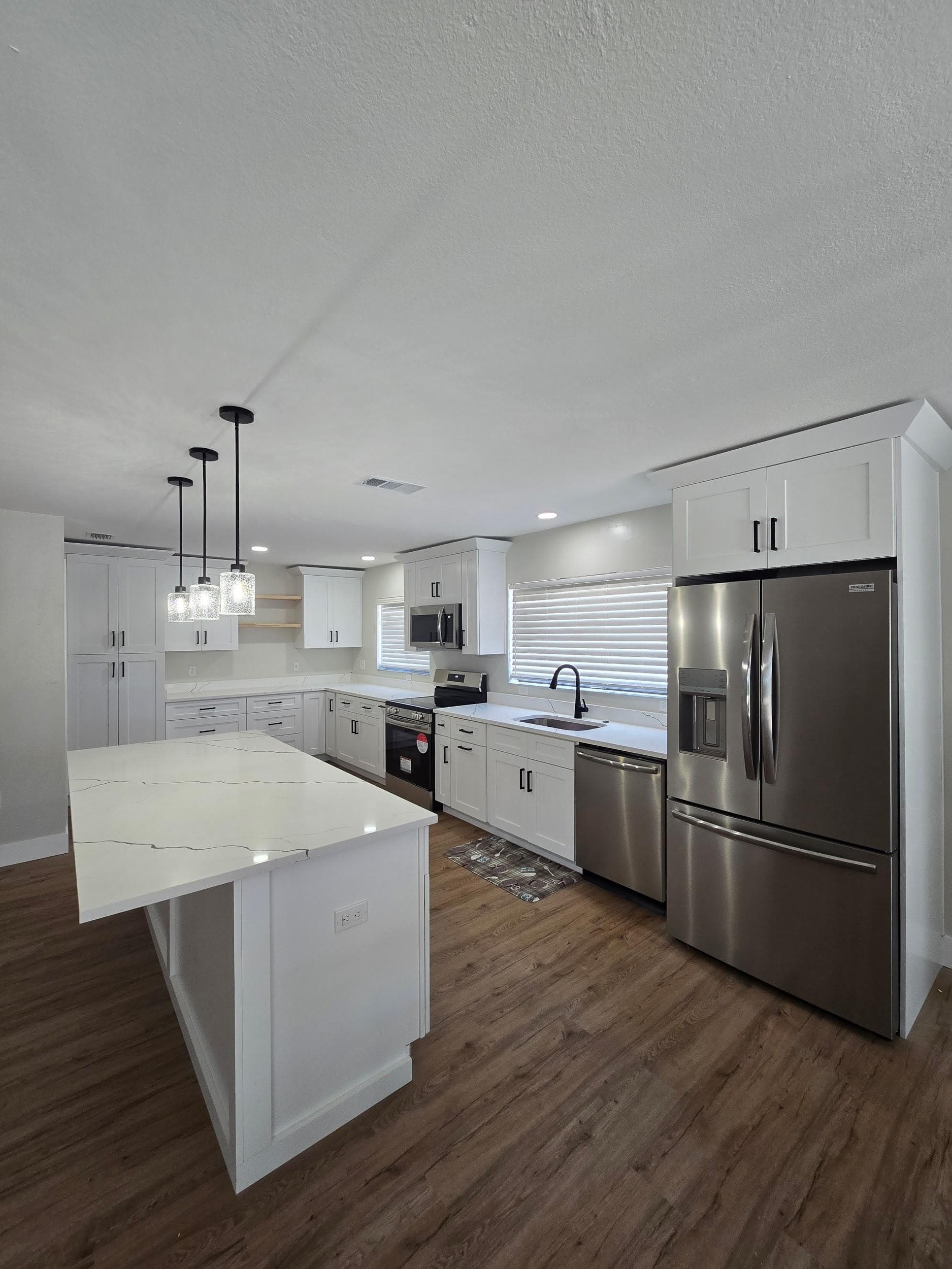Kitchen remodeling in New Tampa FL with custom cabinets, quartz or granite countertops, backsplash, modern lighting, open concept design and new flooring