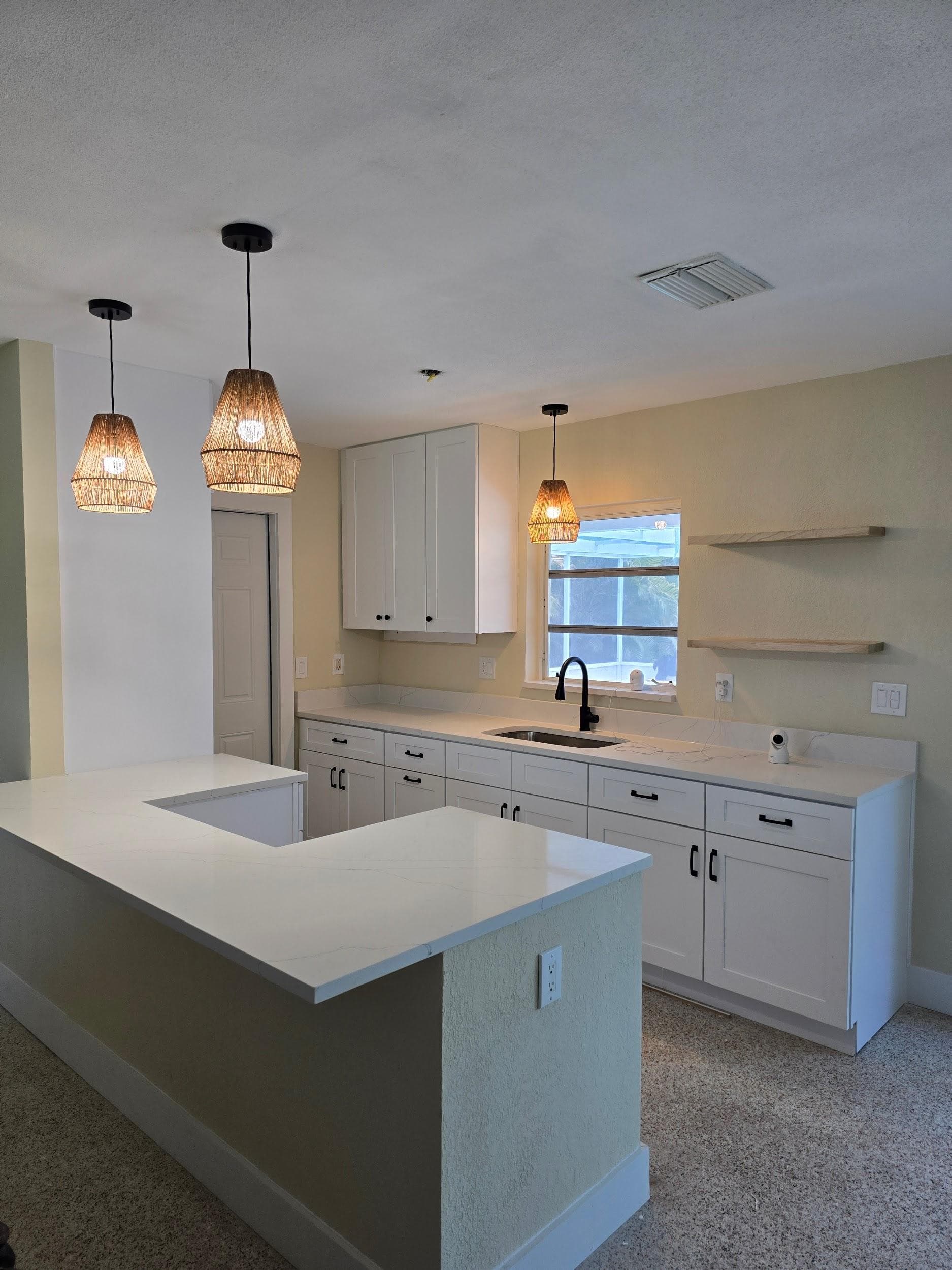 Kitchen remodeling in Temple Terrace FL with custom cabinets, quartz or granite countertops, backsplash, modern lighting, open concept design and new flooring
