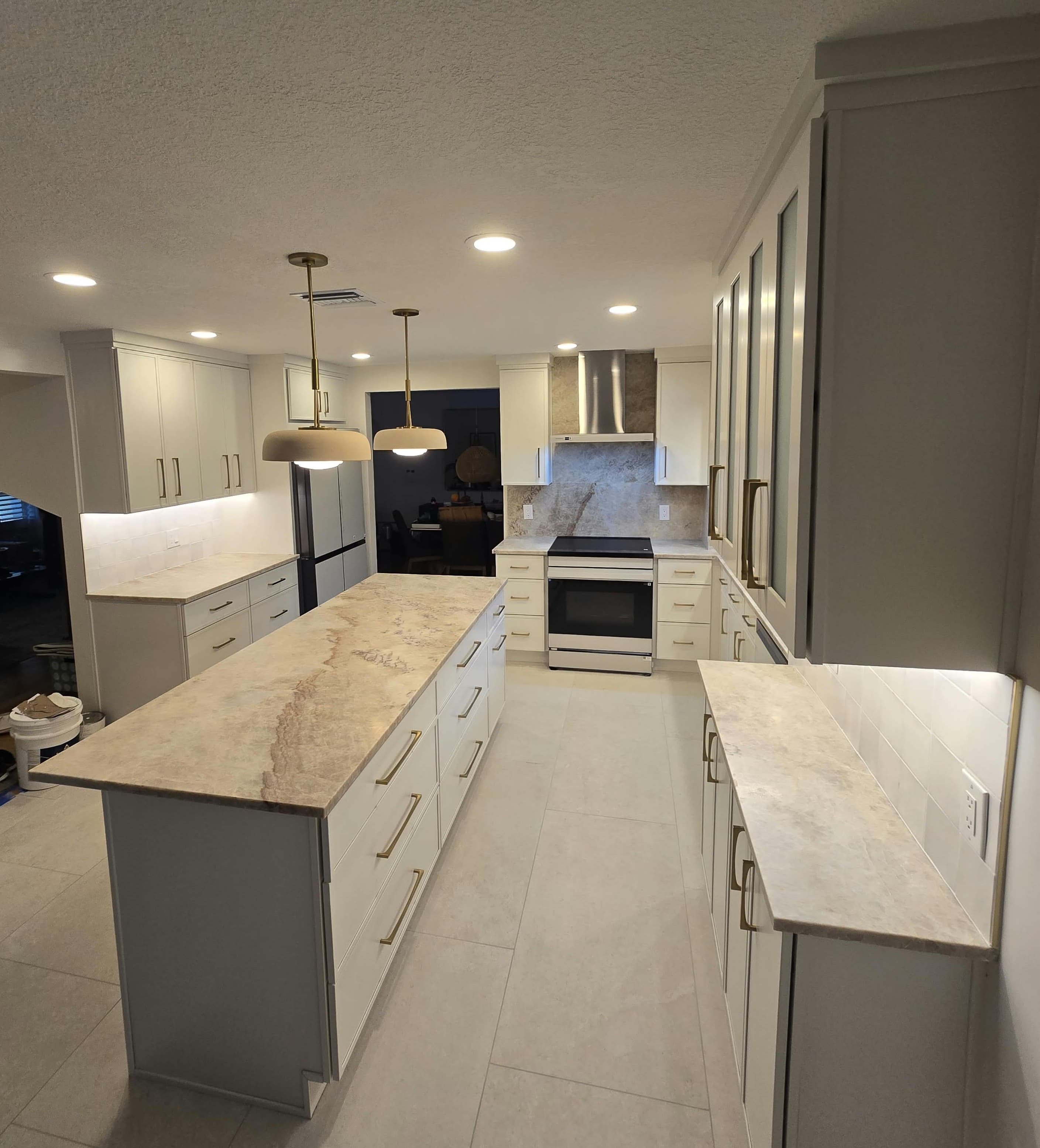 Kitchen remodeling in Tampa FL with custom cabinets, quartz or granite countertops, backsplash, modern lighting, open concept design and new flooring