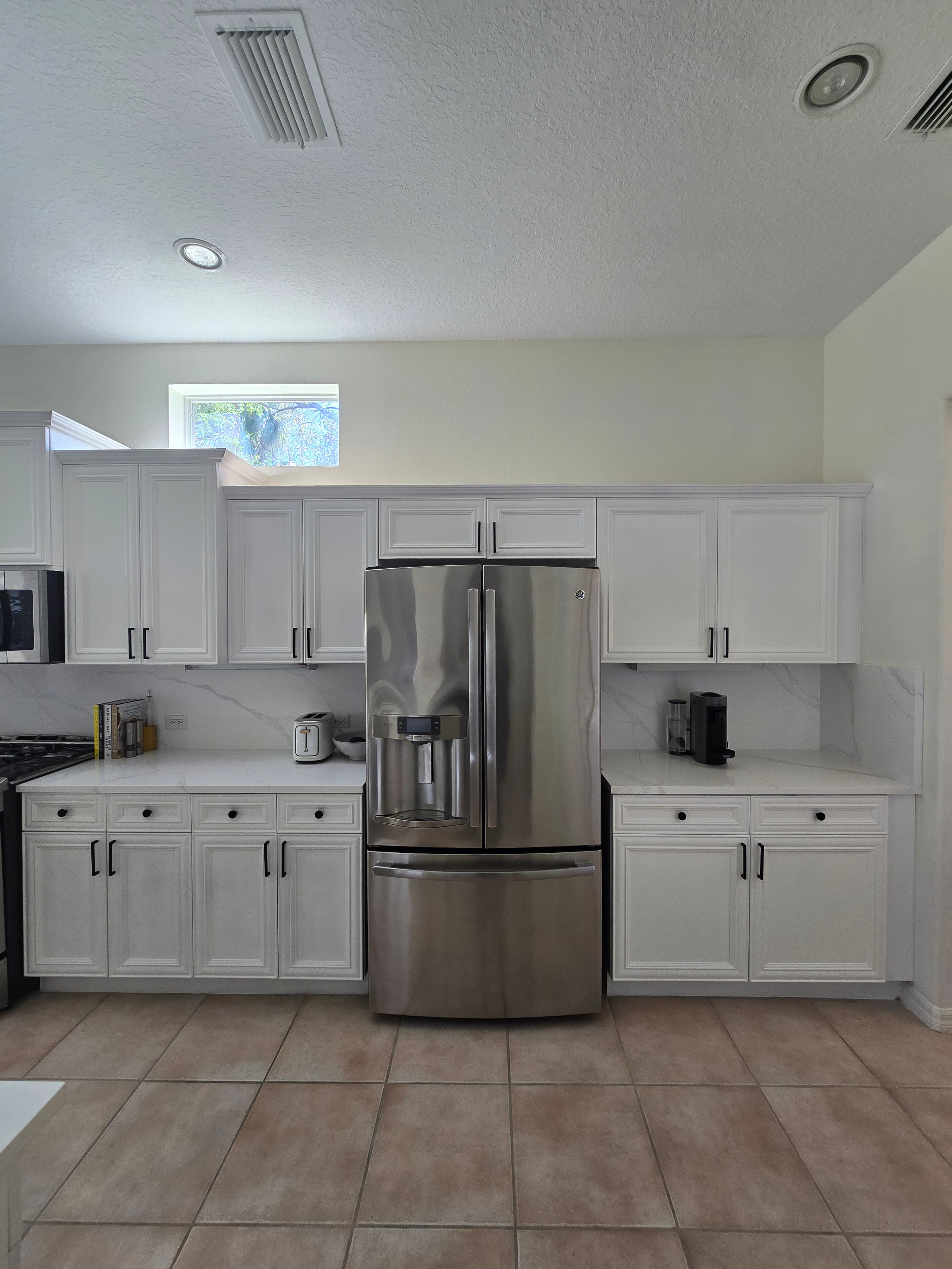 Kitchen remodeling in Northdale FL with custom cabinets, quartz or granite countertops, backsplash, modern lighting, open concept design and new flooring