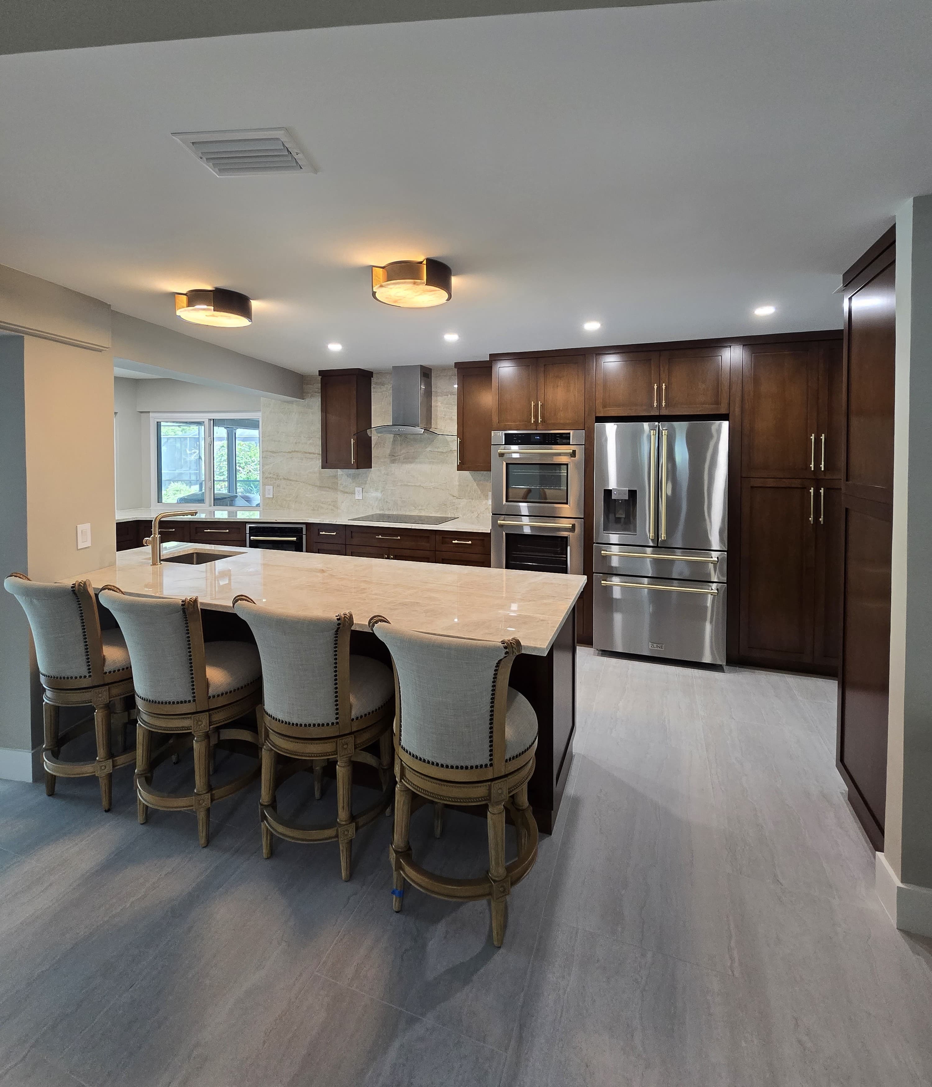 Kitchen remodeling in Lutz FL with custom cabinets, quartz or granite countertops, backsplash, modern lighting, open concept design and new flooring