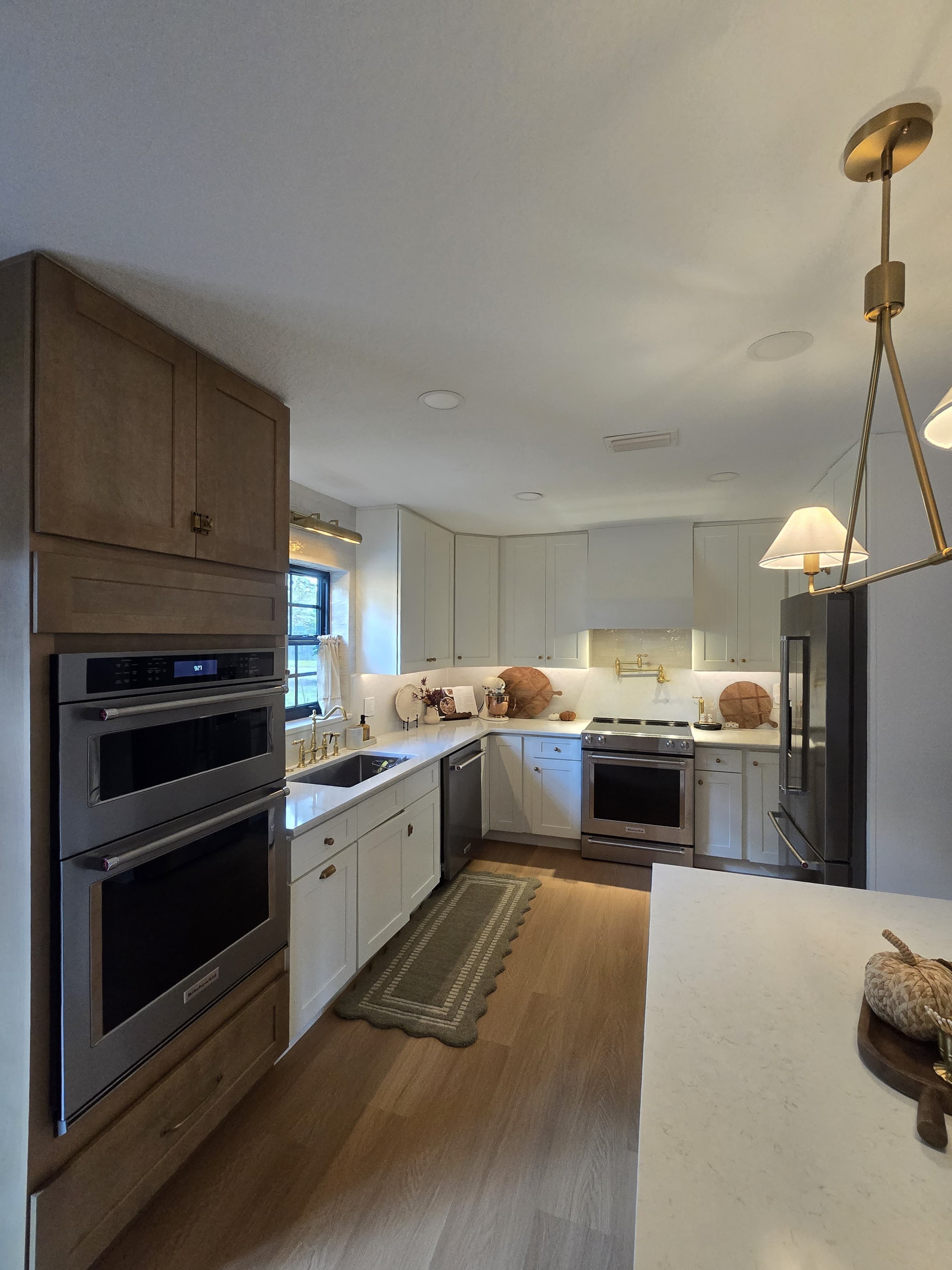 Kitchen remodeling in Safety Harbor FL with custom cabinets, quartz or granite countertops, backsplash, modern lighting, open concept design and new flooring