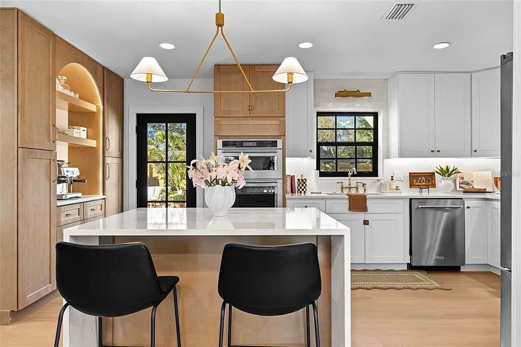 Open concept kitchen remodeling in Pinellas County FL with custom cabinets, quartz or granite countertops, backsplash, modern lighting and new flooring